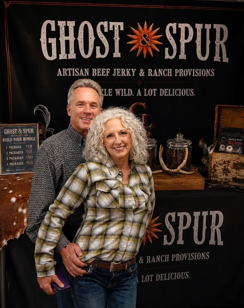 Ghost & Spur owners standing together at their market booth in Prescott, Arizona